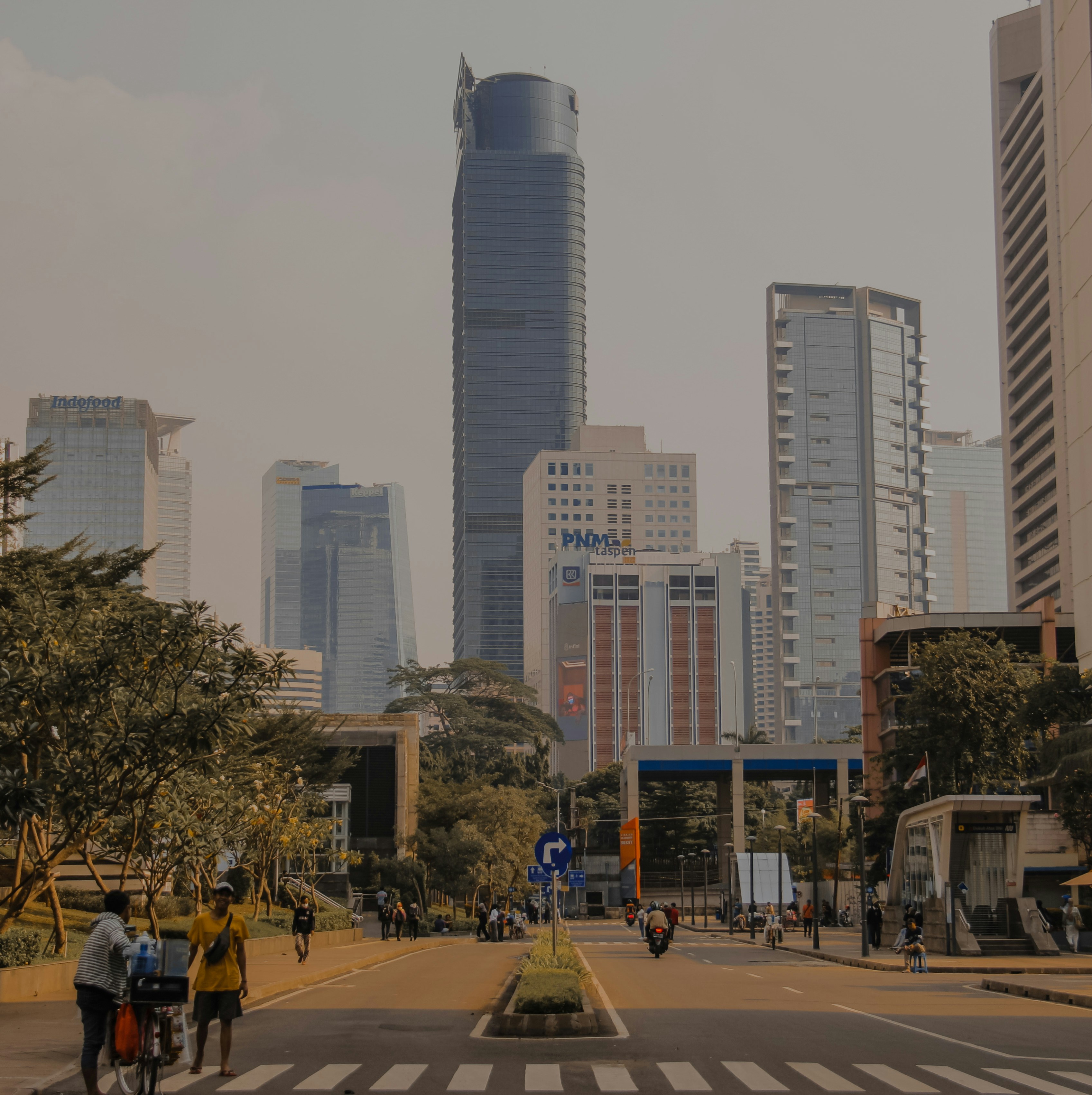 a group of people riding bikes down a street