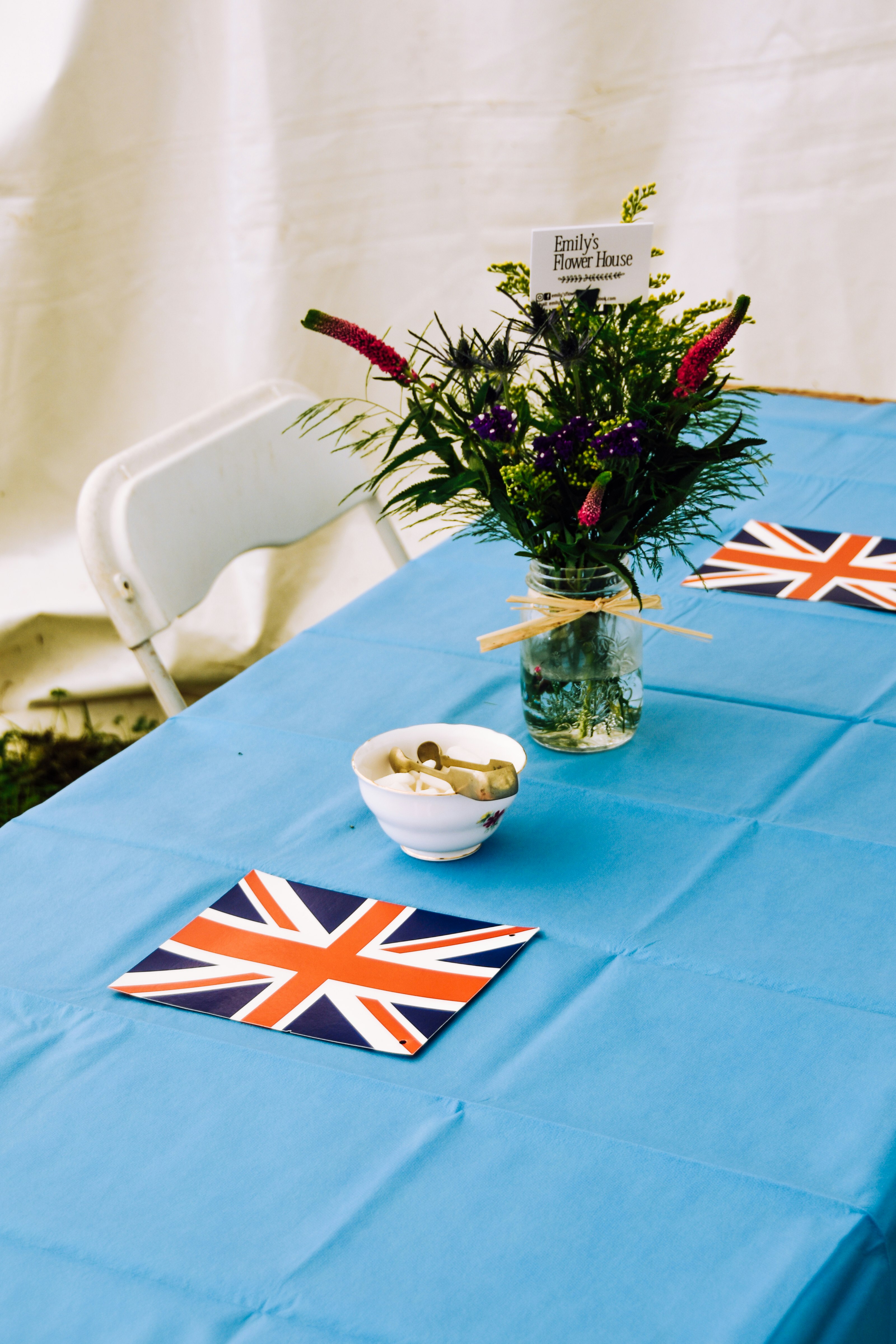 purple flowers in clear glass vase on blue table