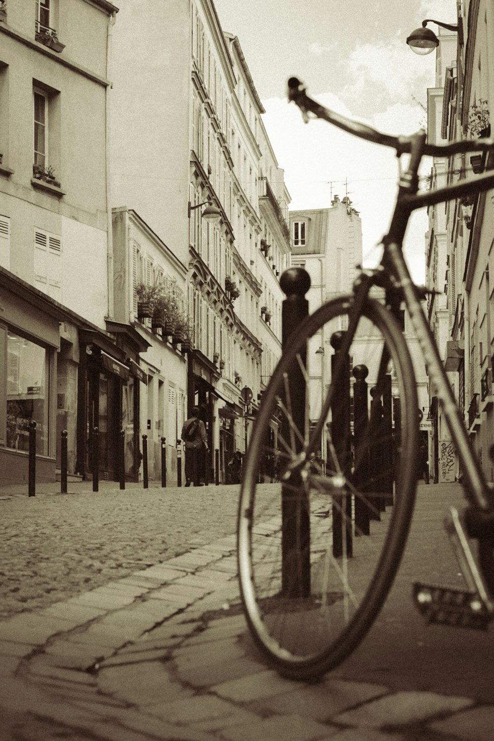 a bicycle is parked on a cobblestone street