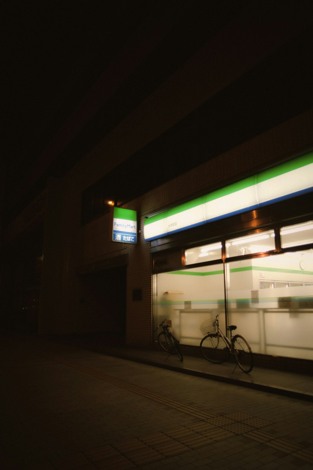 black bicycle parked near white and green building