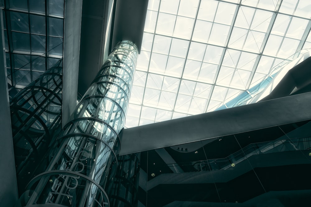 a very tall glass and steel structure in a building