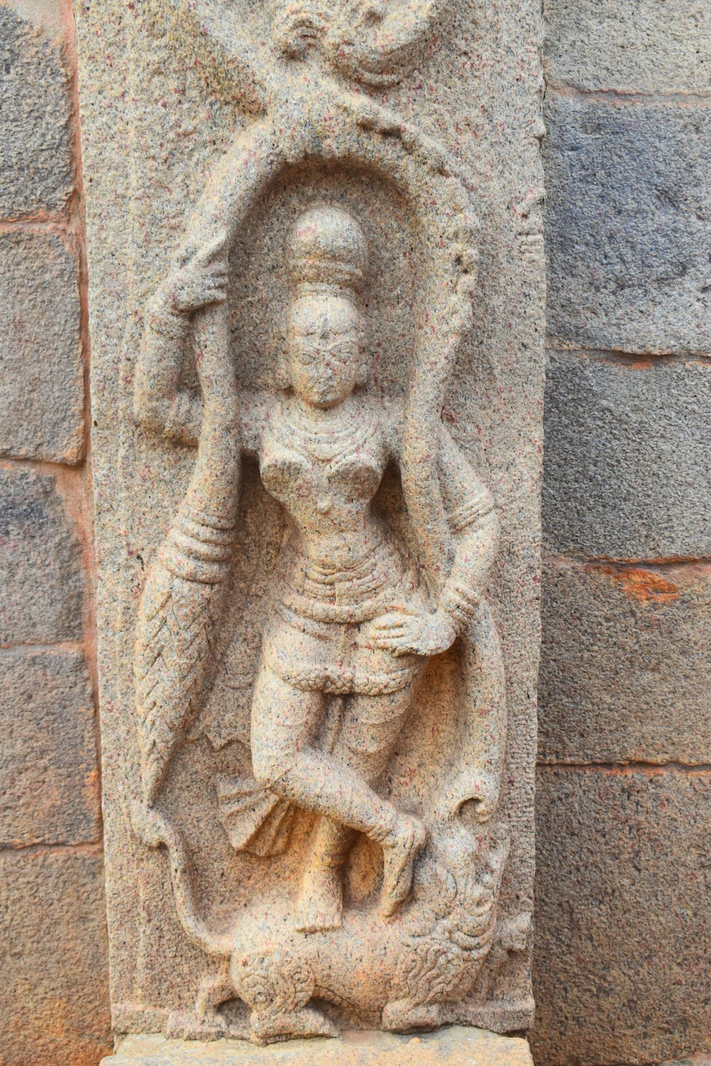 a stone statue of a woman holding a bird