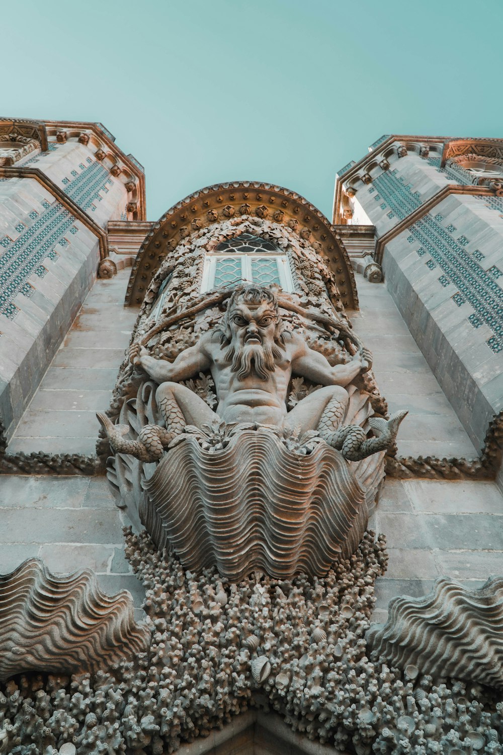 a close up of a statue on the side of a building