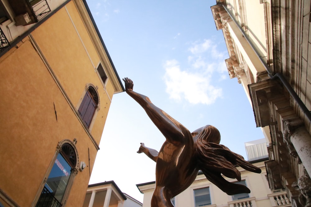 man in black shorts jumping on brown concrete building during daytime