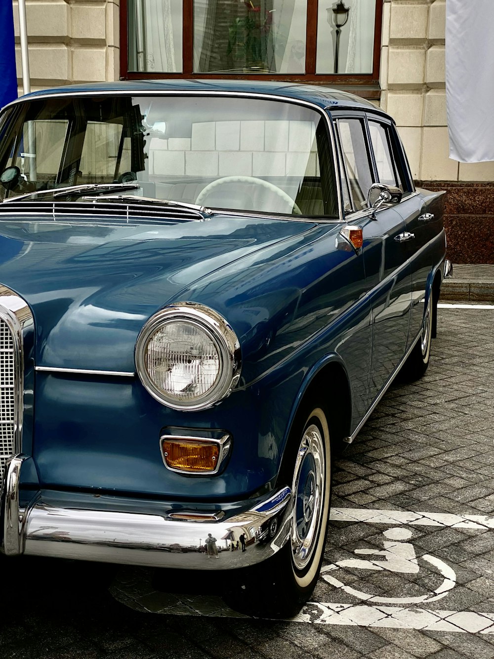 a blue car parked on the side of the road