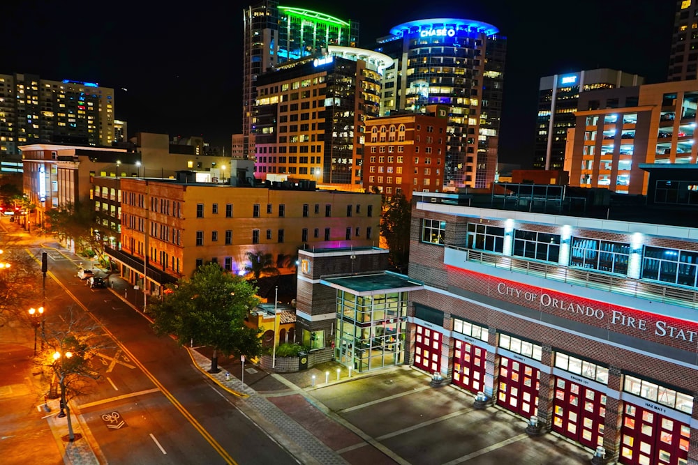 a city street at night with buildings lit up