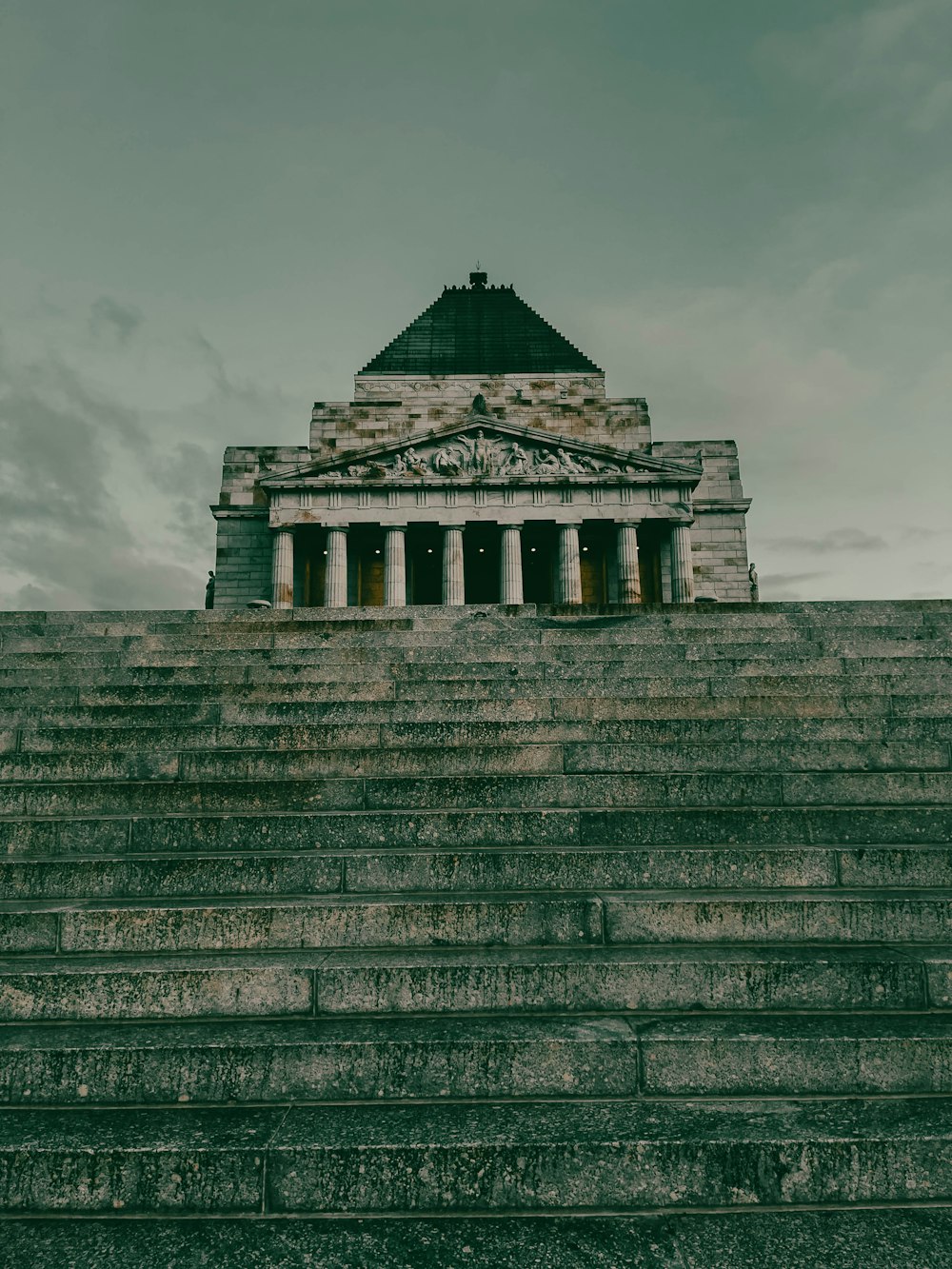 a very tall building with columns on top of it