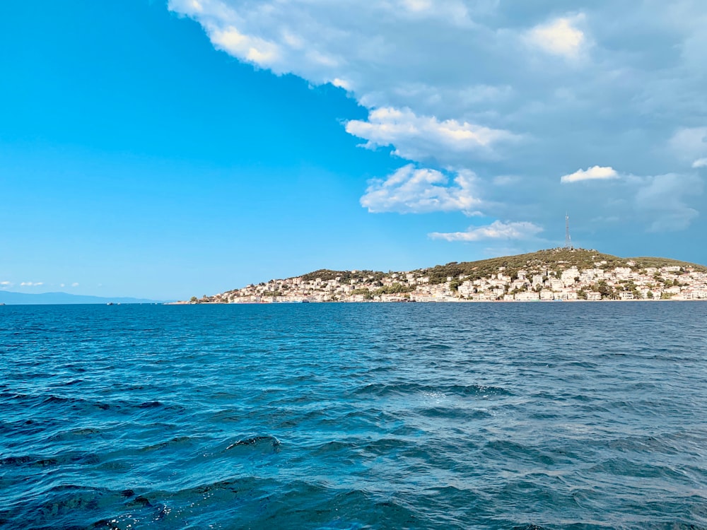 a large body of water with a small island in the background