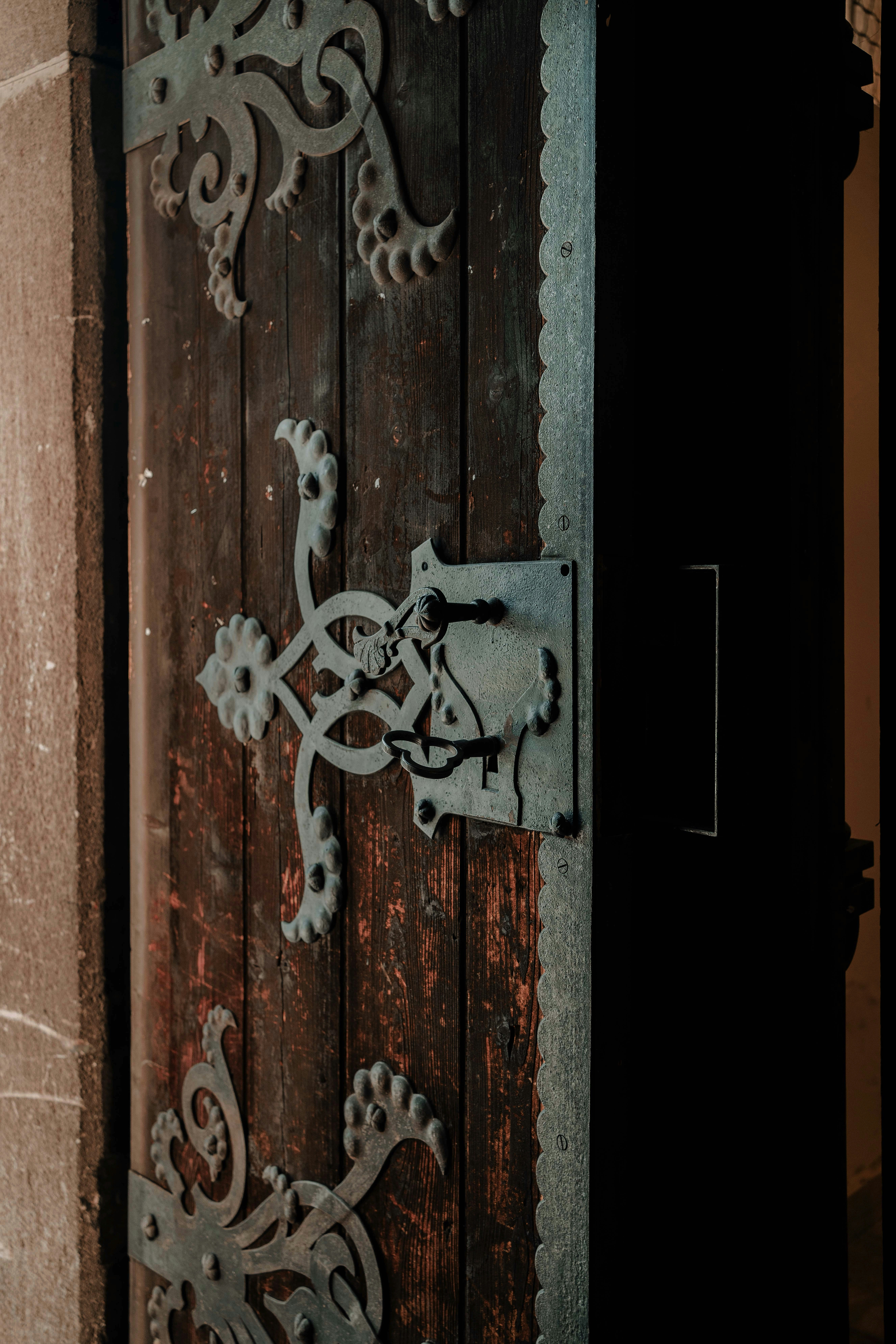 a close up of a wooden door with a metal handle