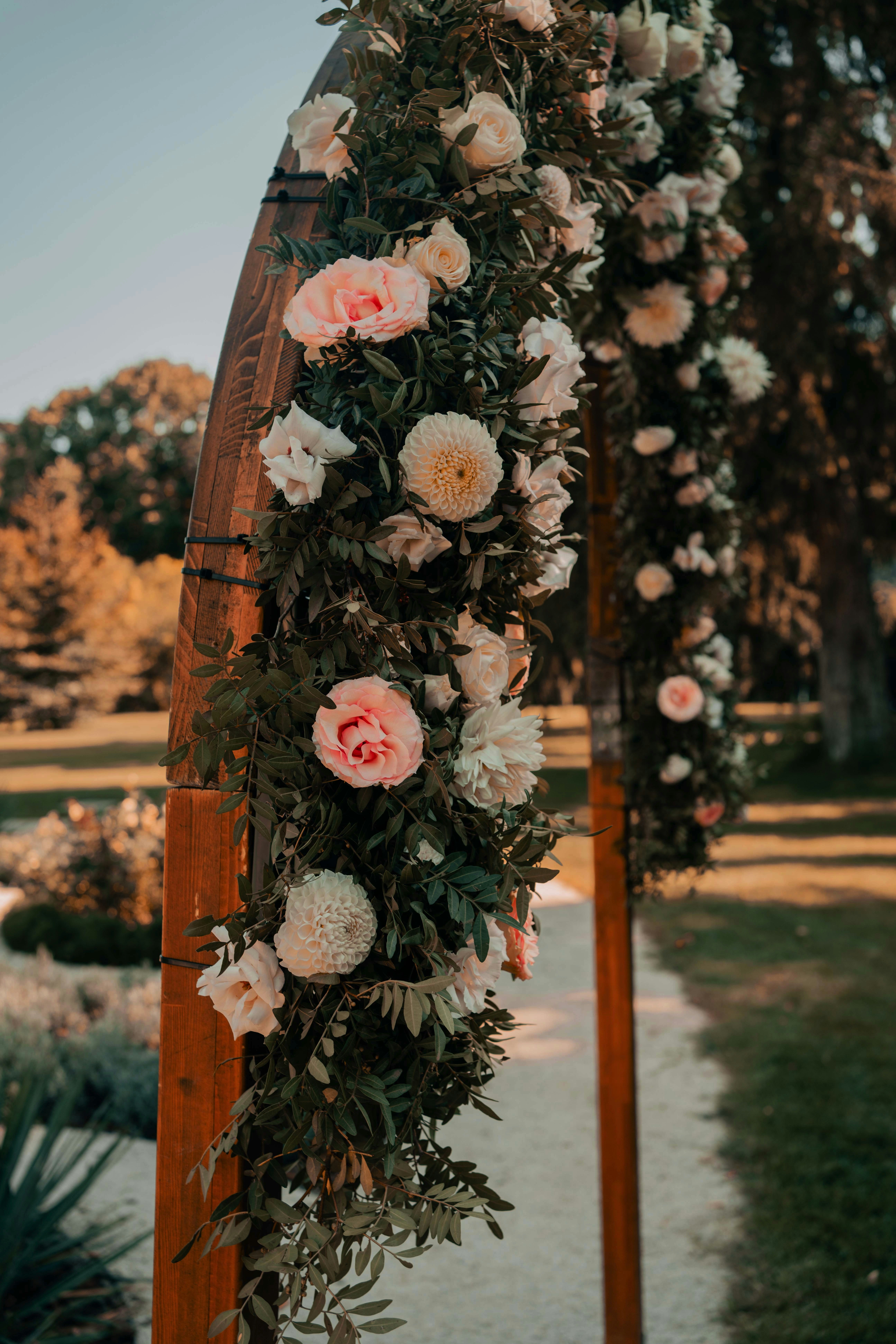 Lush blush and white floral wedding ceremony arch with peonies and roses
