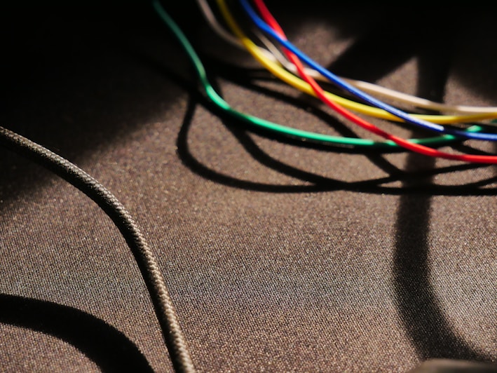 A vibrant display of electrical cables and connectors neatly arranged on a blue background.