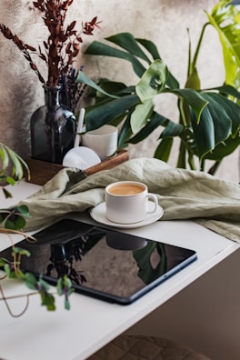 A serene morning scene with a coffee cup and a tablet showing stock updates.
