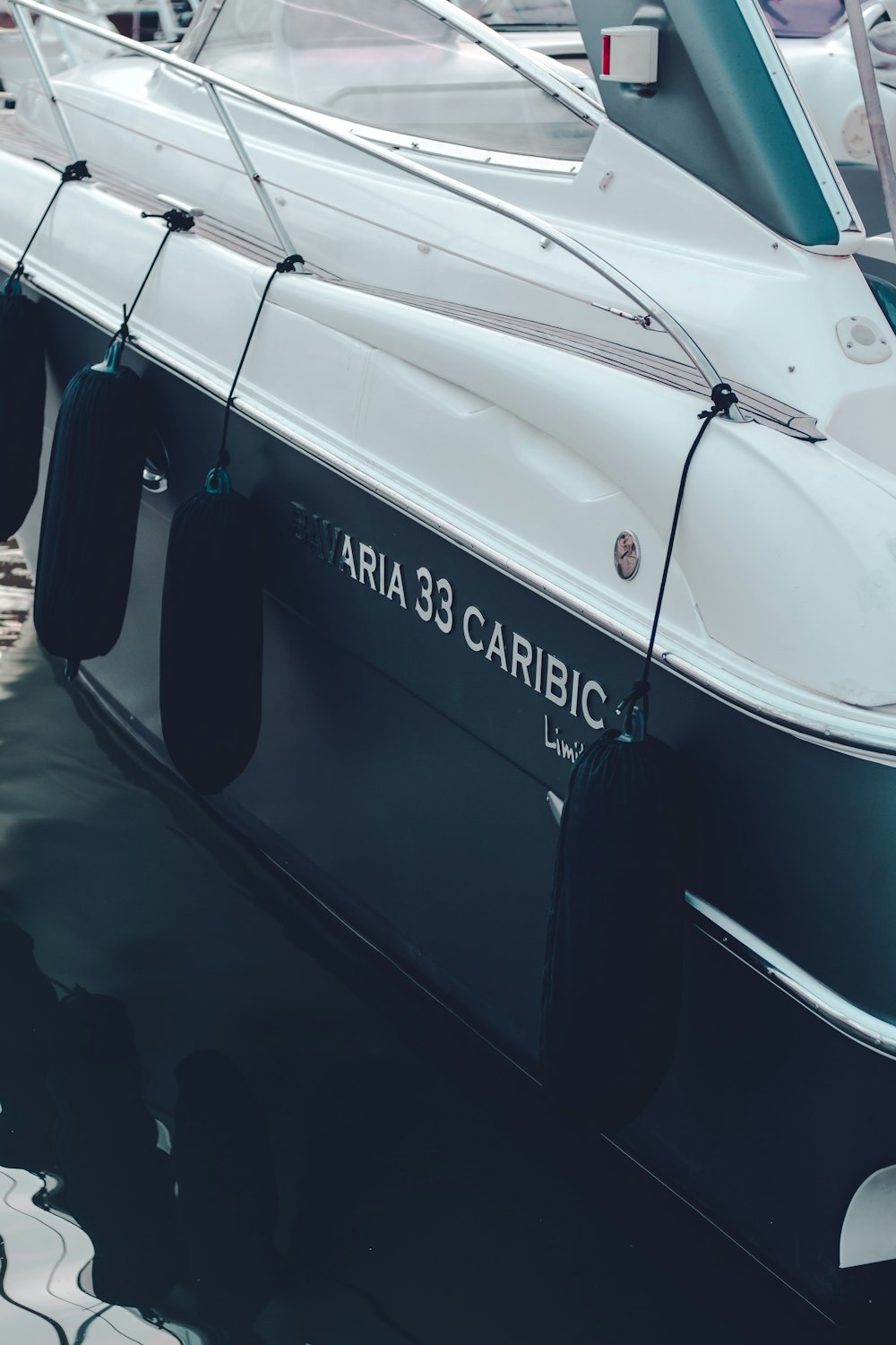 a black and white boat docked at a marina