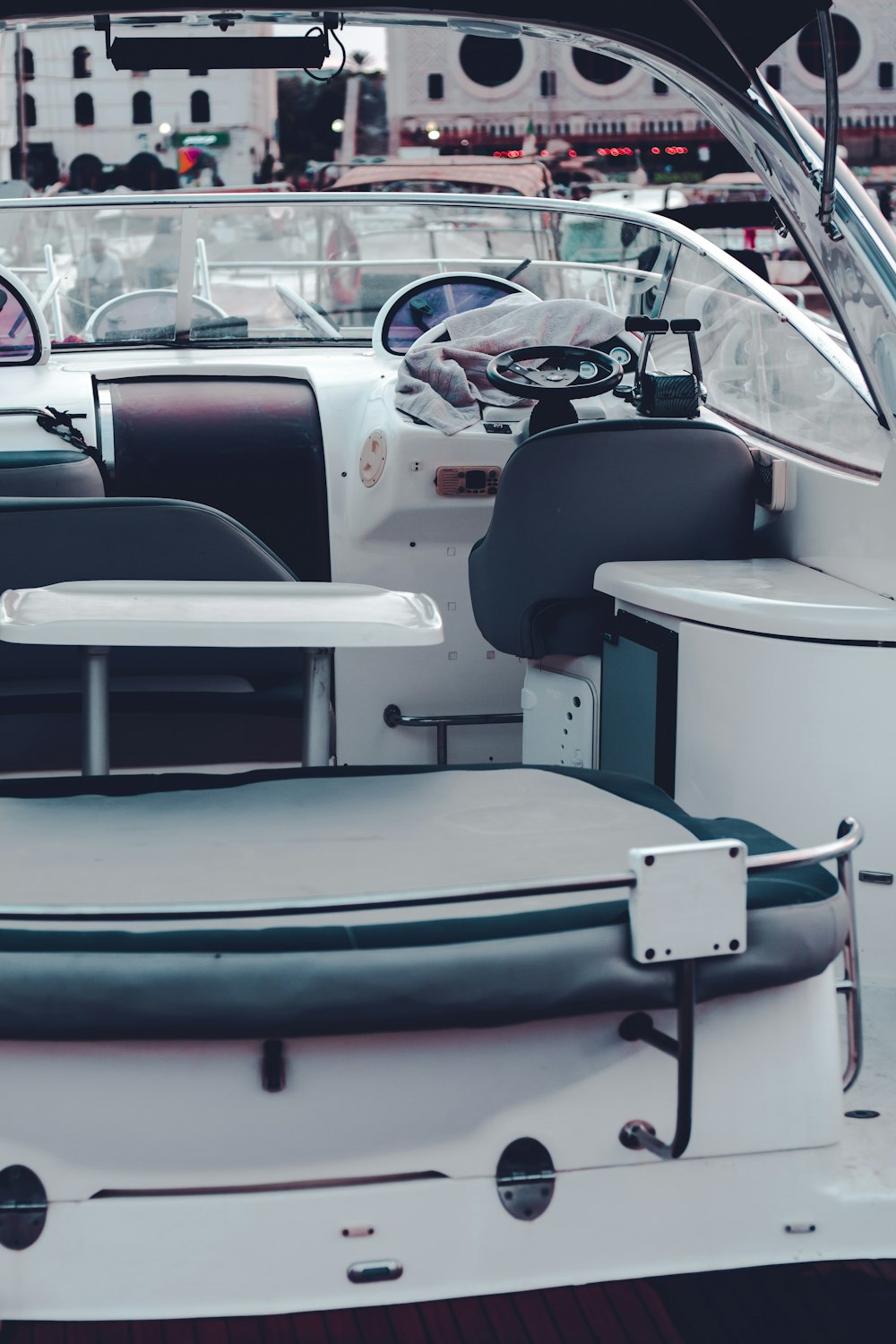 the inside of a boat with seats and a steering wheel
