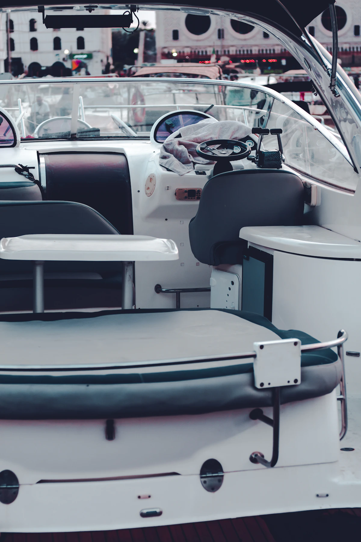 Boat interior with marine upholstery showing seats and helm station