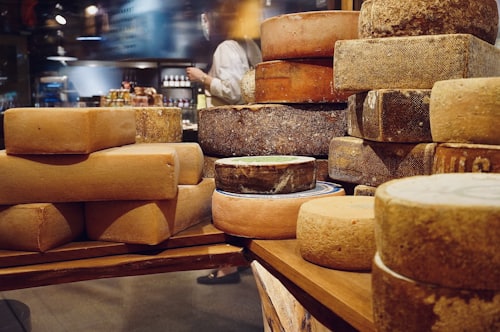 Variety of Italian artisan cheeses on a wooden board