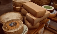 Close-up of creamy cheeses with natural textures and rich colors