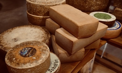 Selection of dairy products including cheese and milk bottles on a wooden table