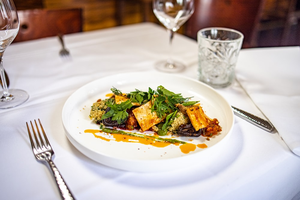 a white plate topped with food on top of a table