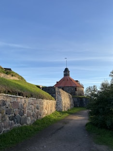 a stone wall with a building on top of it