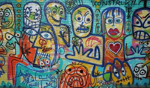 a wall covered in lots of colorful graffiti