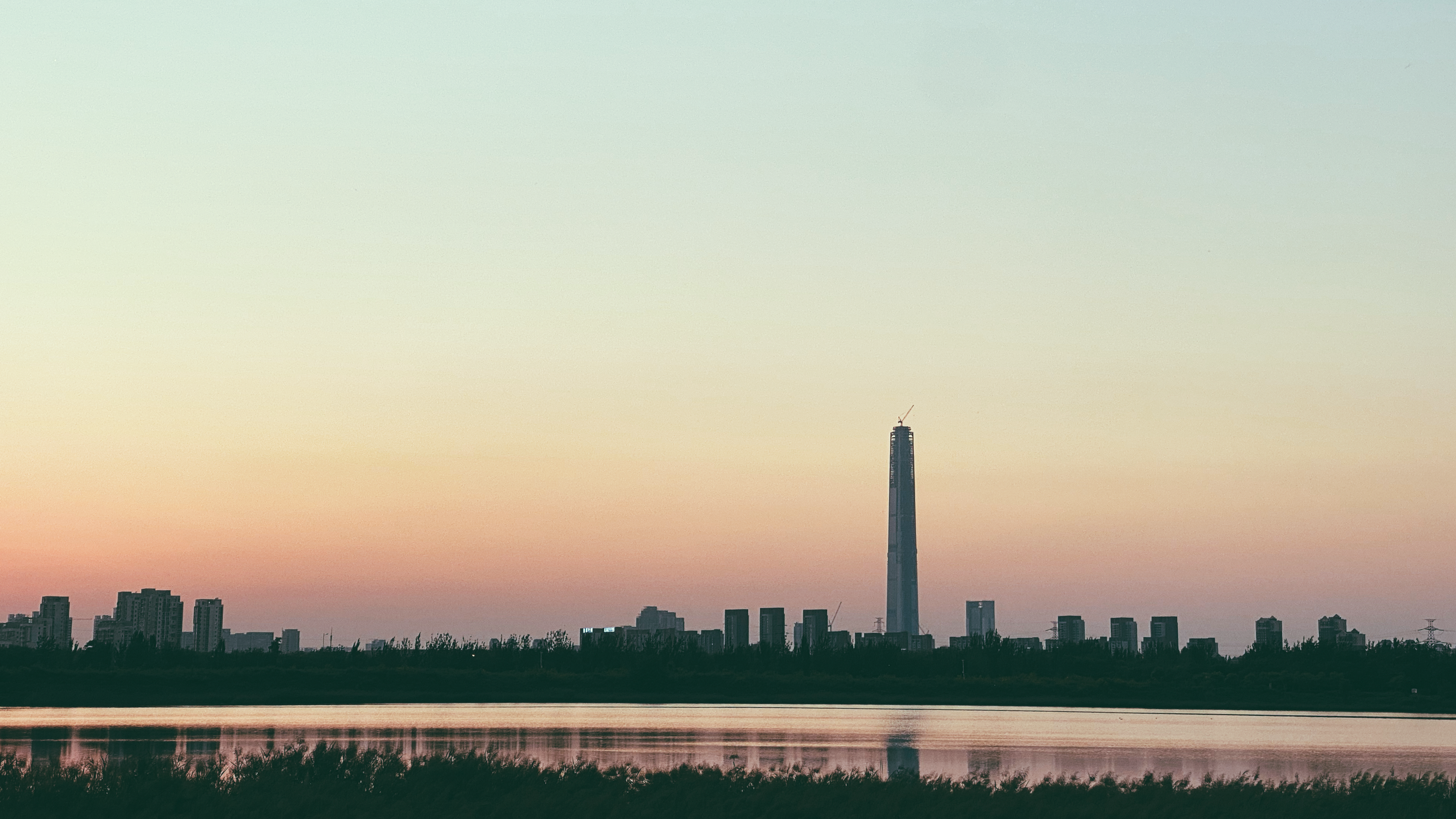 a large body of water with a city in the background