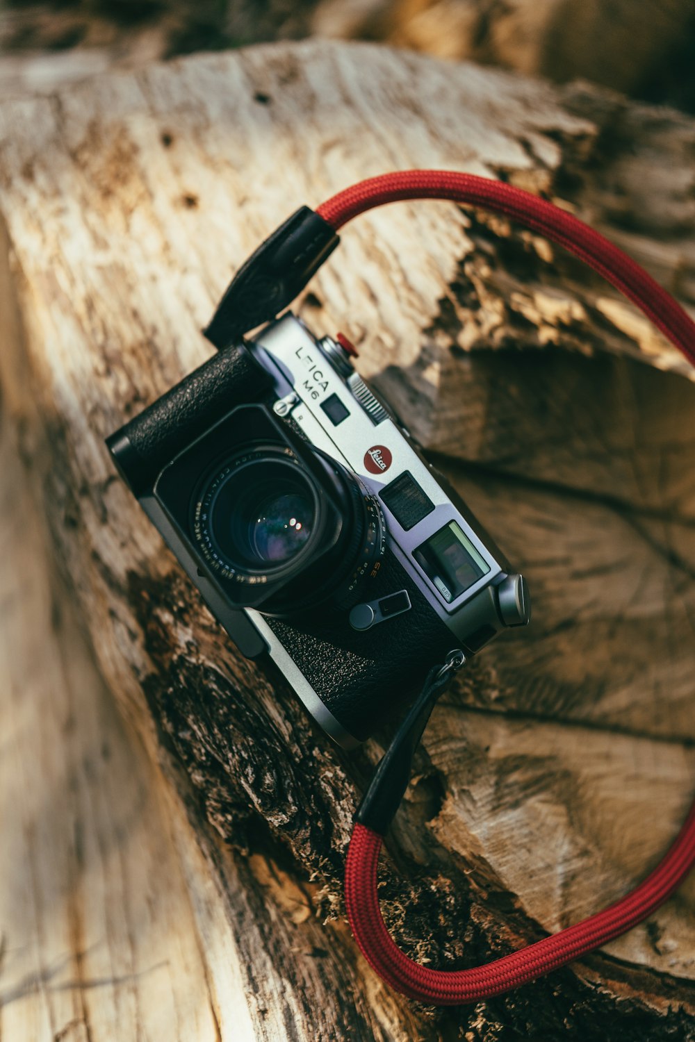 a camera sitting on top of a piece of wood