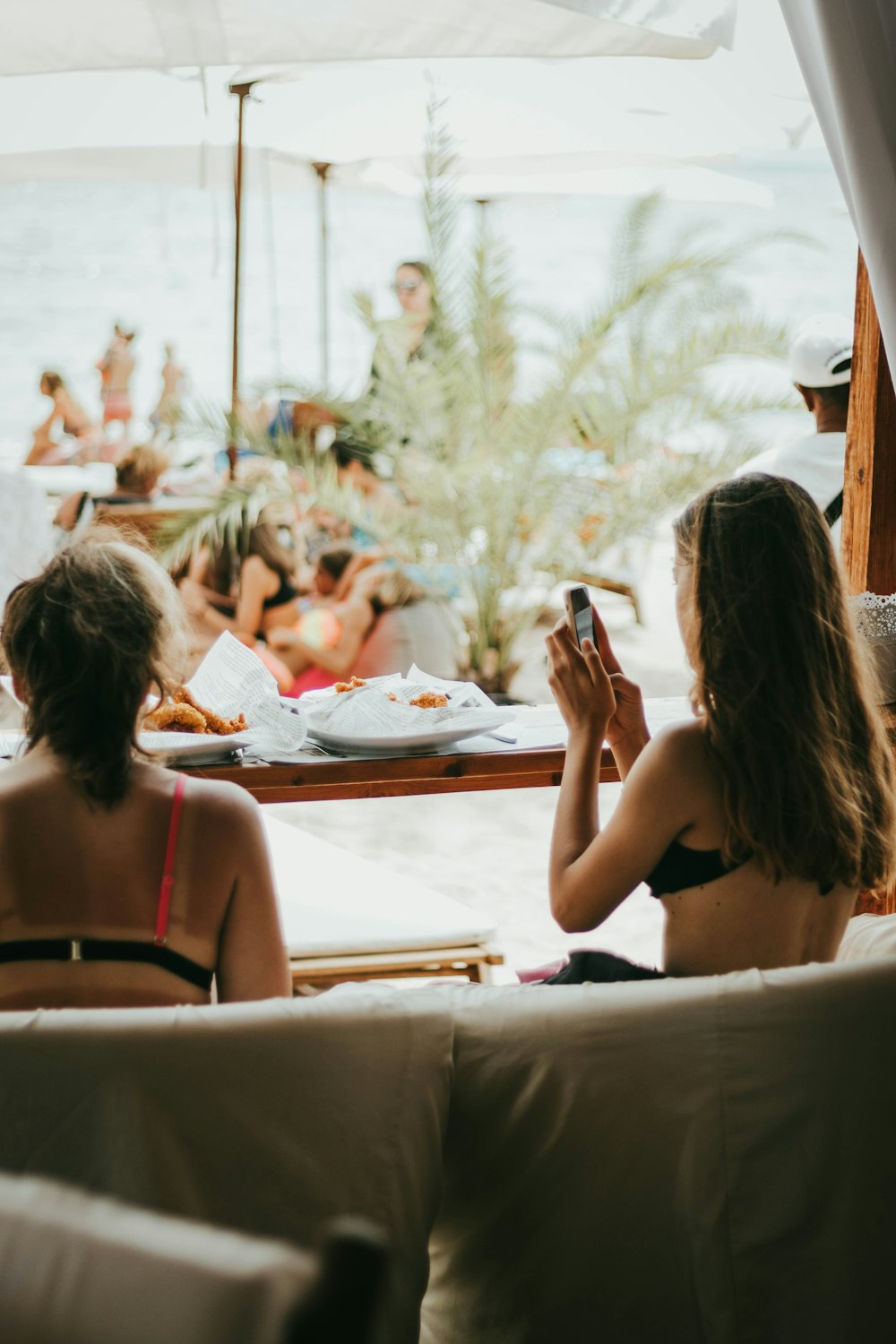 a couple of women sitting on top of a couch