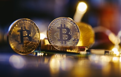 two bitcoins sitting on top of each other on a table