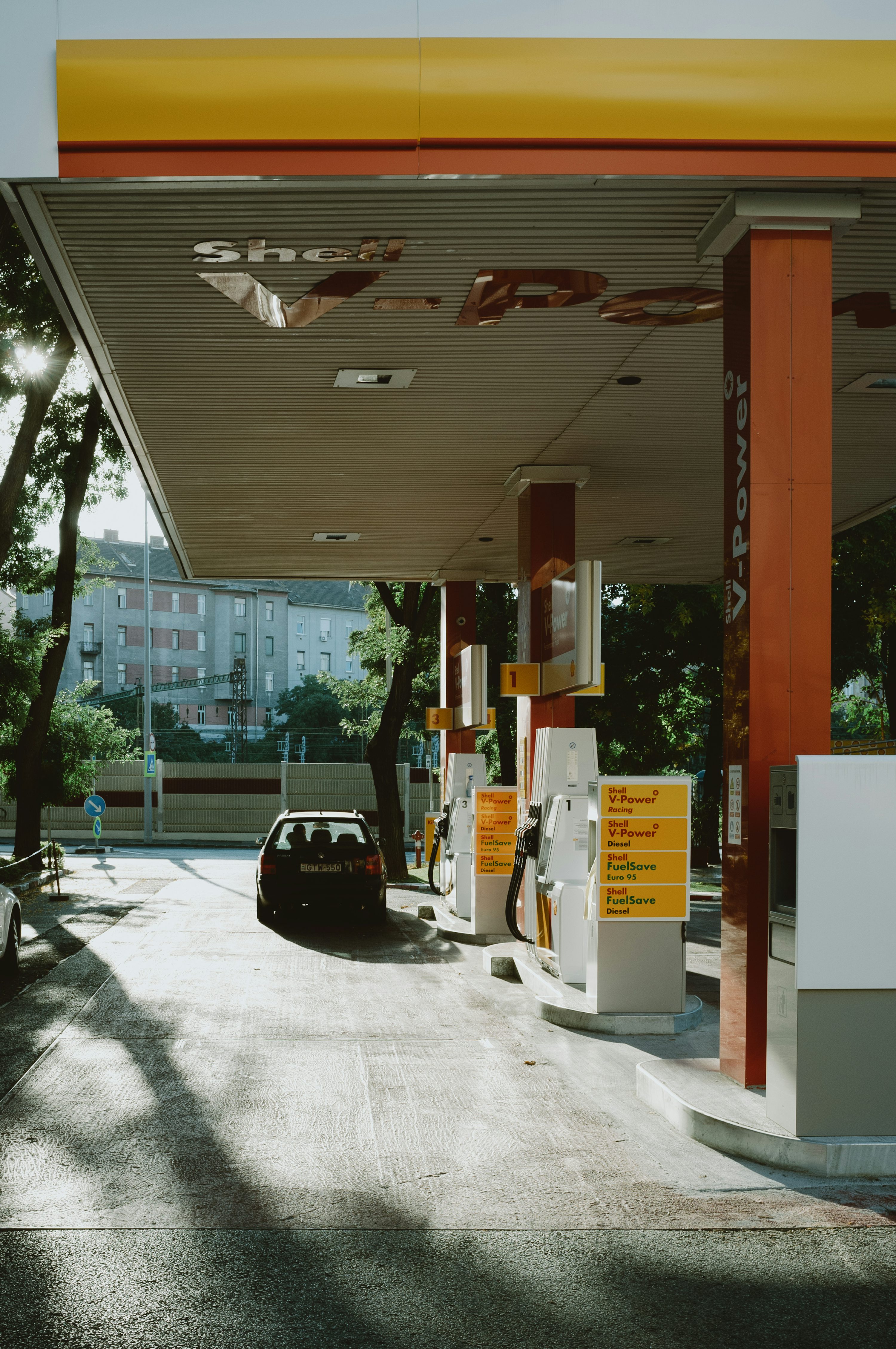 black car parked near white and brown building during daytime