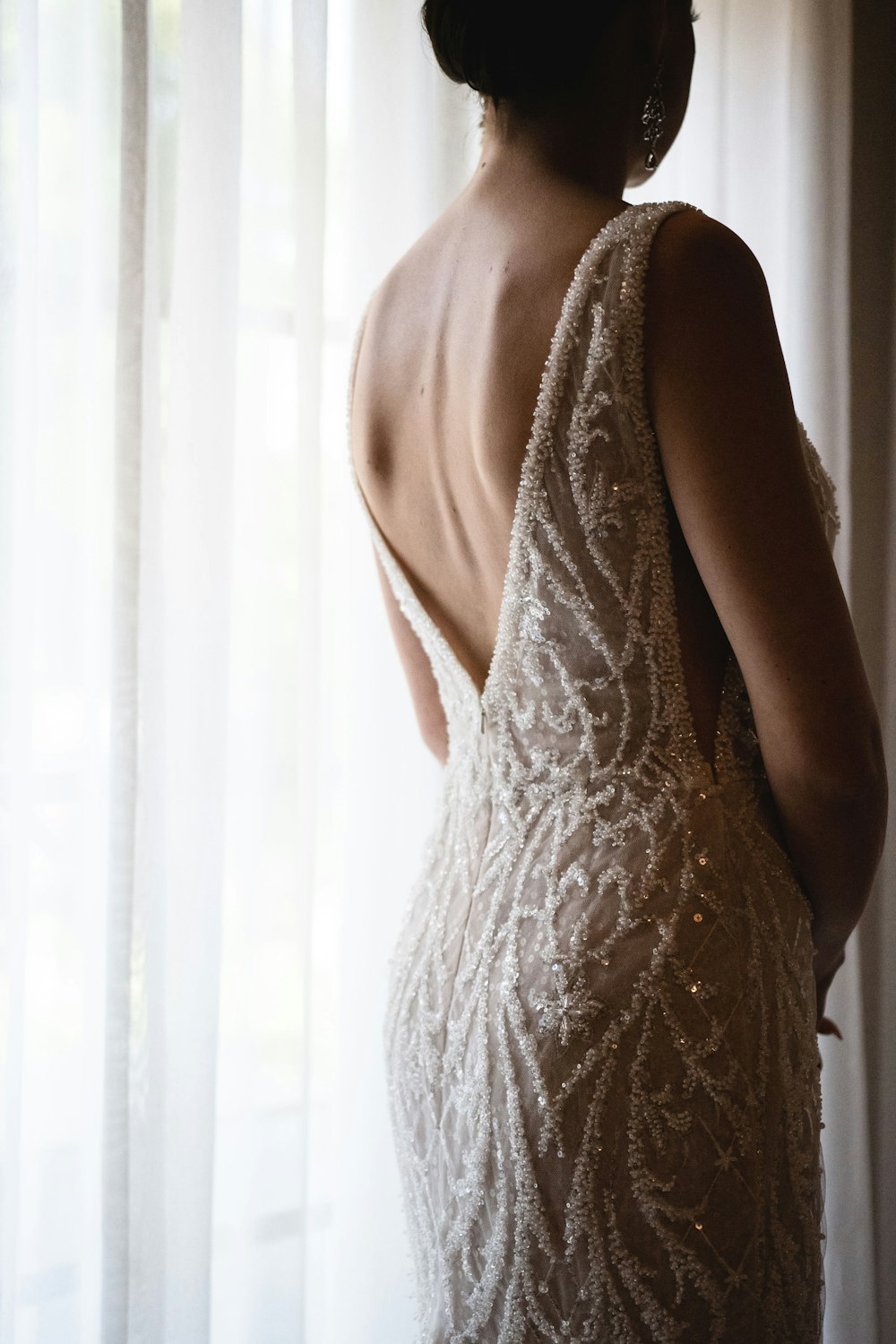 the back of a woman's dress in front of a window