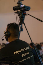 a man sitting in a chair in front of a camera