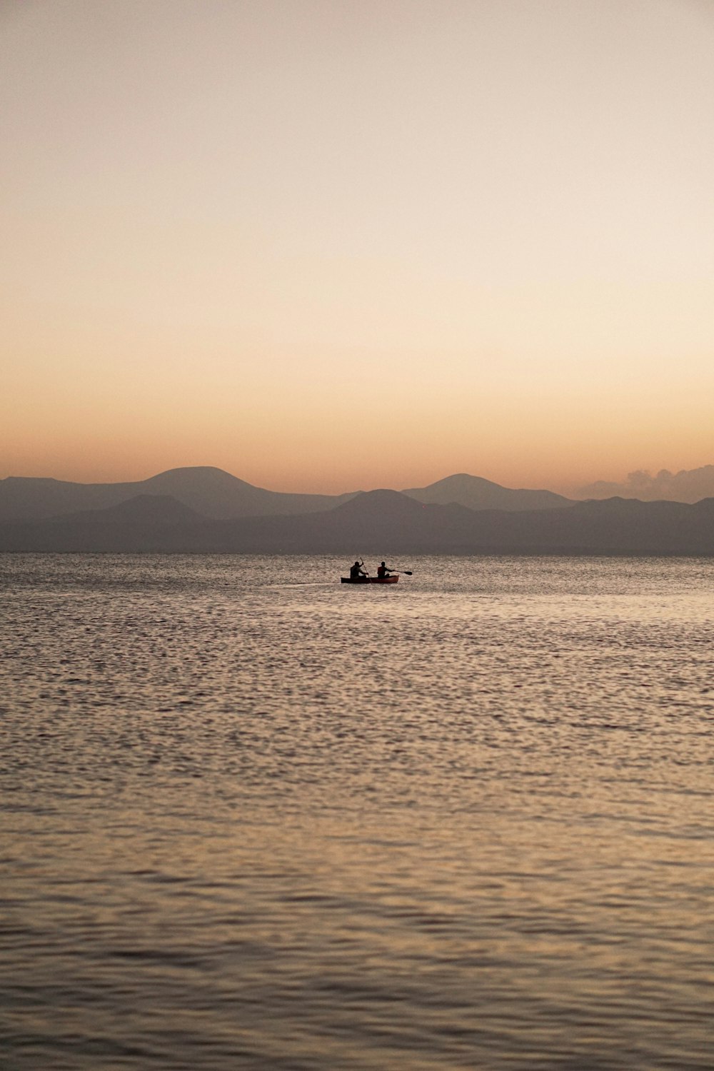 a couple of boats floating on top of a large body of water