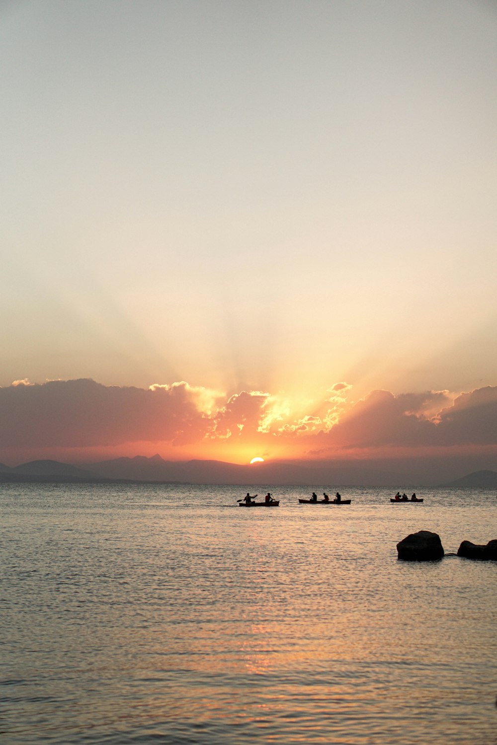 a group of boats floating on top of a large body of water