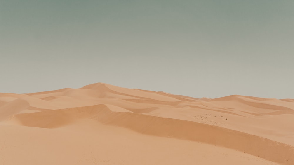 brown sand under blue sky during daytime