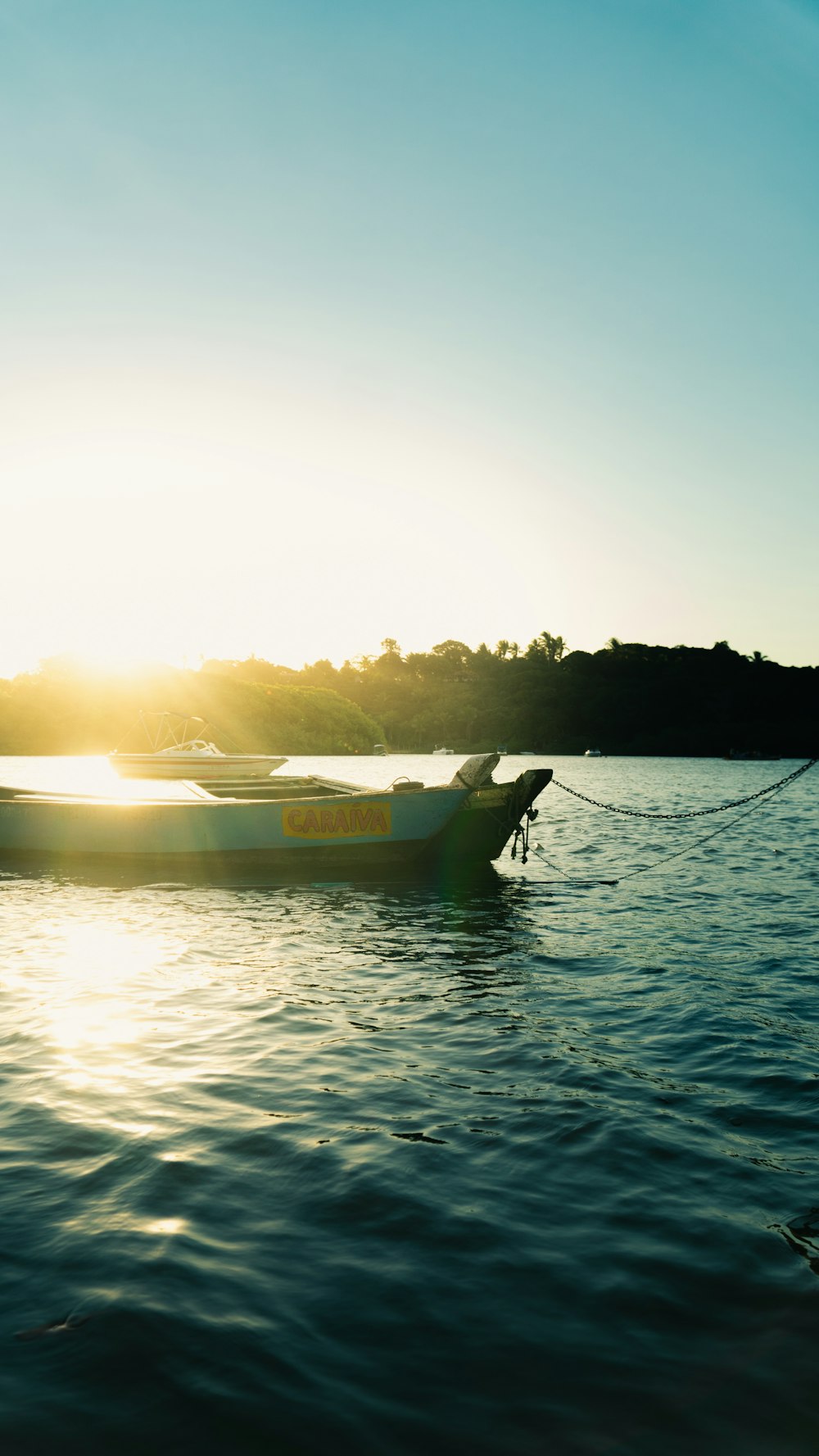 a couple of boats floating on top of a lake