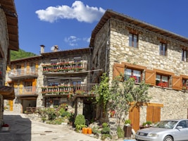 a car parked in front of a stone building