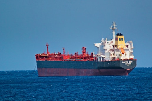 red and white cargo ship on sea during daytime