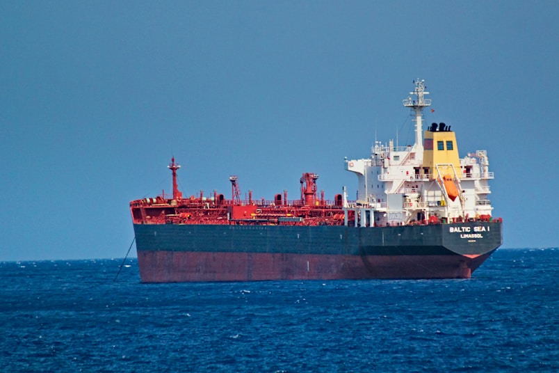 red and white cargo ship on sea during daytime