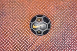 a soccer ball sitting on top of a metal floor