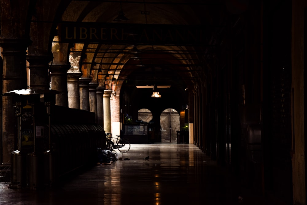 a dimly lit hallway with a train on the tracks