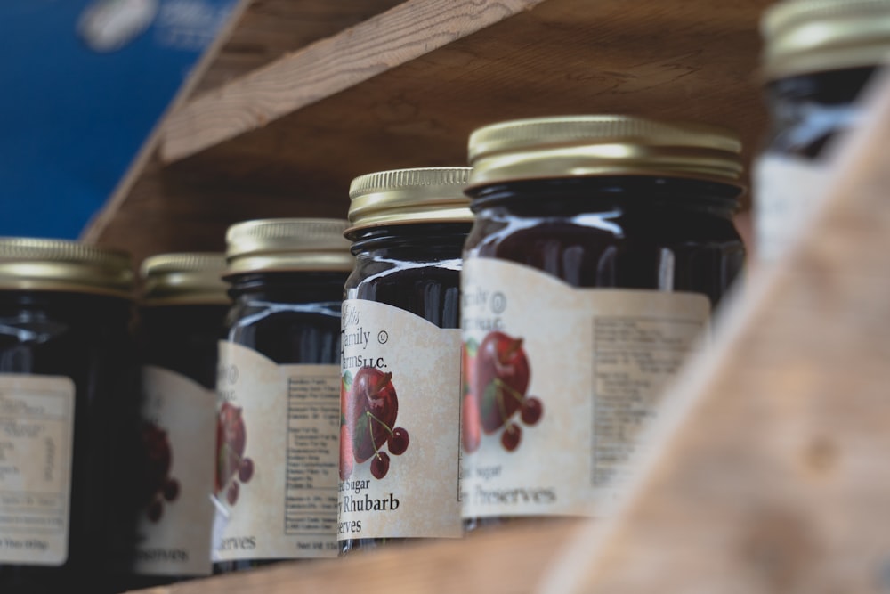 a shelf filled with lots of jars of jam