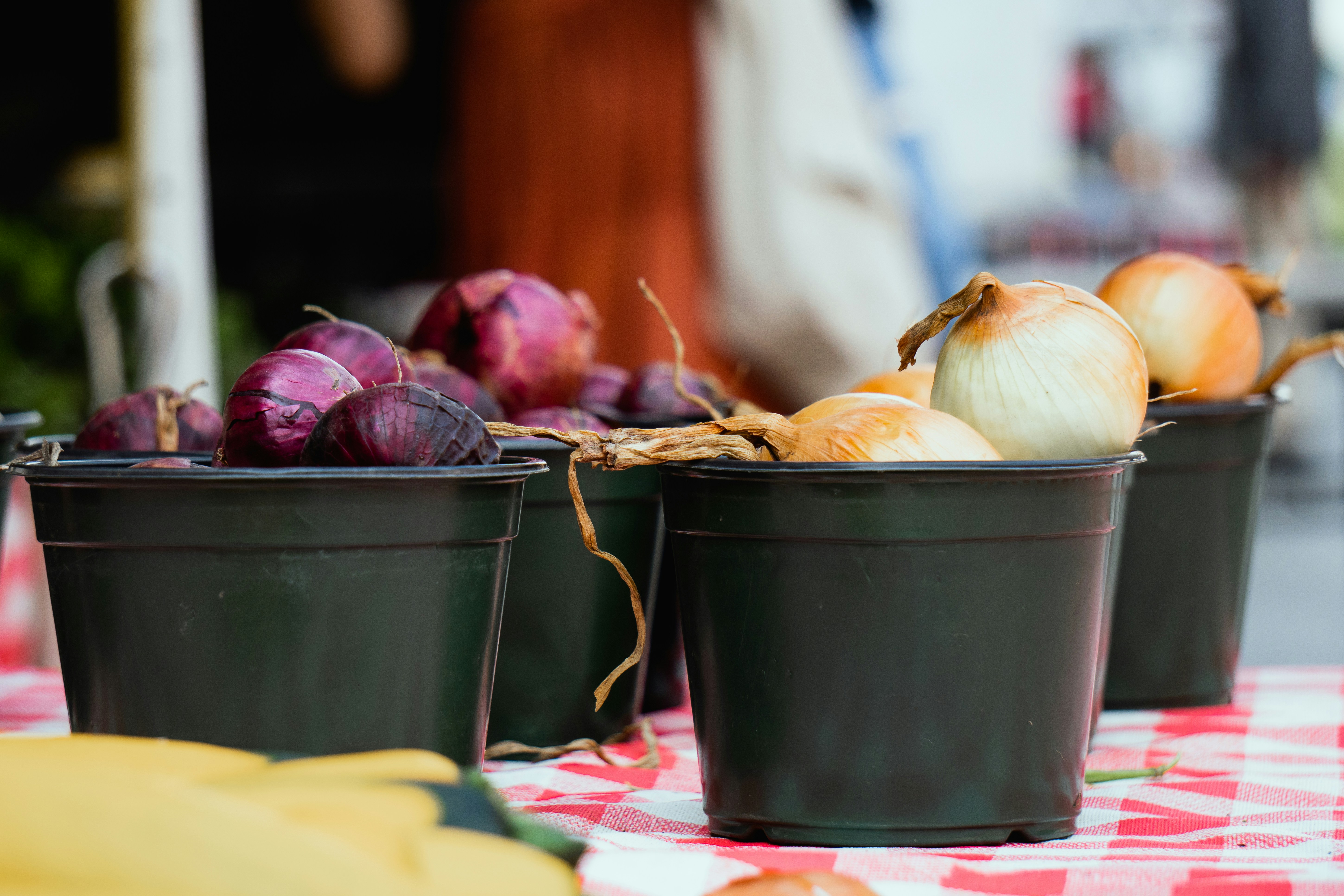a table topped with buckets filled with different types of vegetables