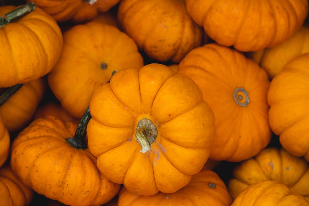 a pile of orange pumpkins sitting next to each other