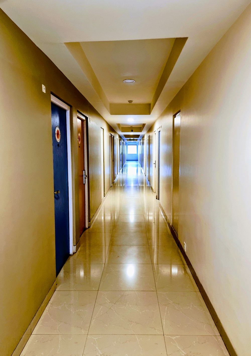 hallway with green doors and doors