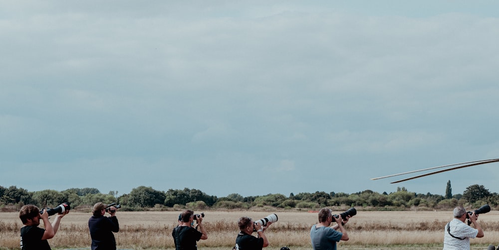 people sitting on grass field during daytime