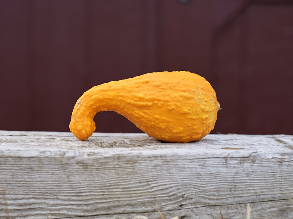 an orange peel sitting on top of a piece of wood