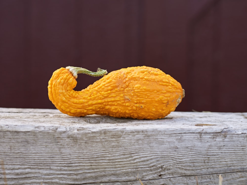 a yellow gourd sitting on top of a wooden table