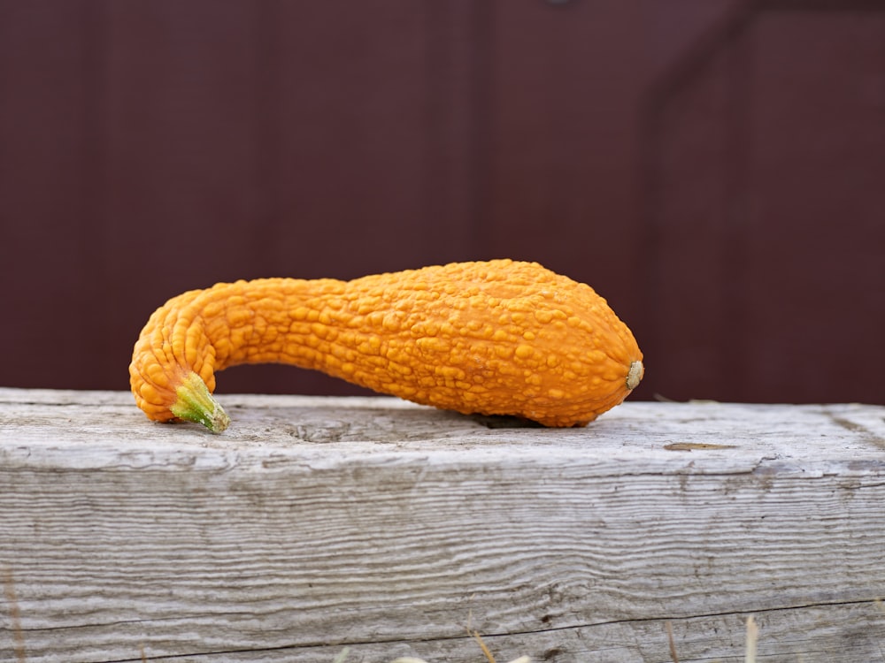 a close up of a piece of fruit on a wooden surface