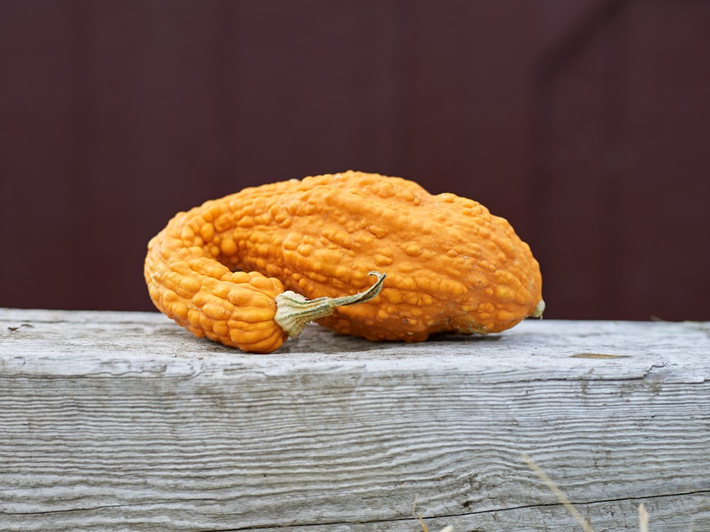 a pumpkin sitting on top of a wooden table